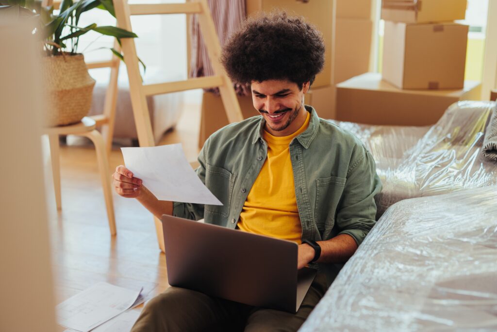 Renter reviewing rental debt paperwork and tenant screening report before applying for an apartment