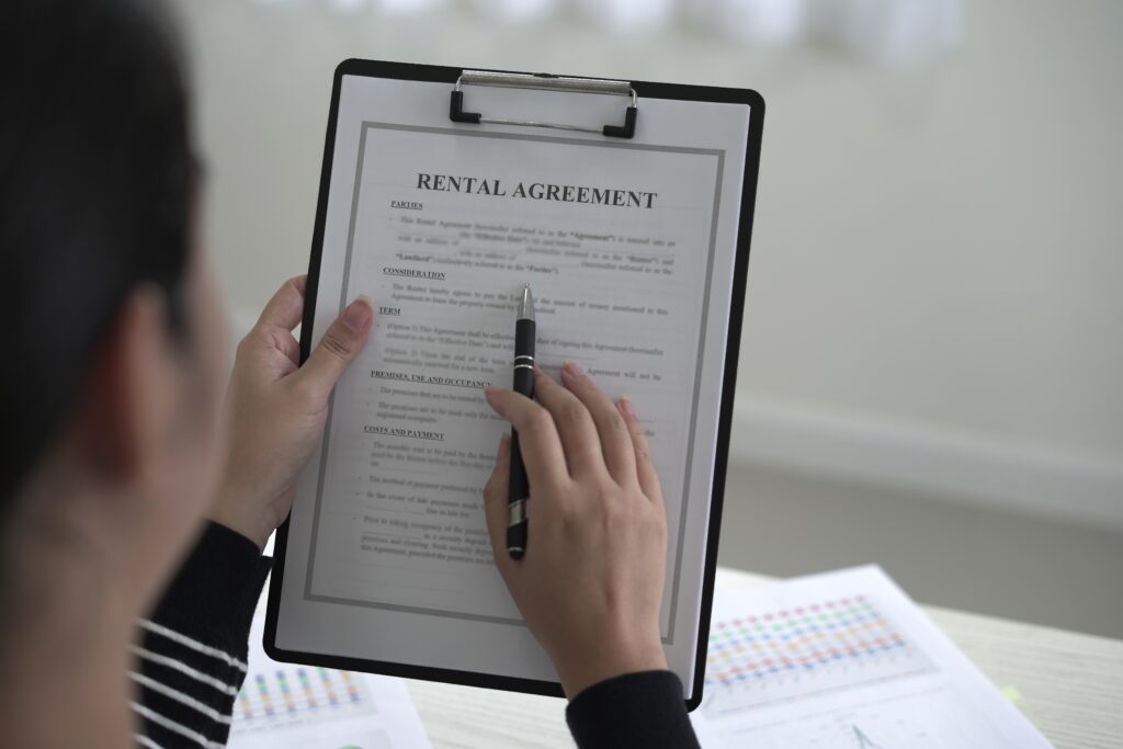 Renter with a new job reviewing offer letter pay stubs and apartment application documents.