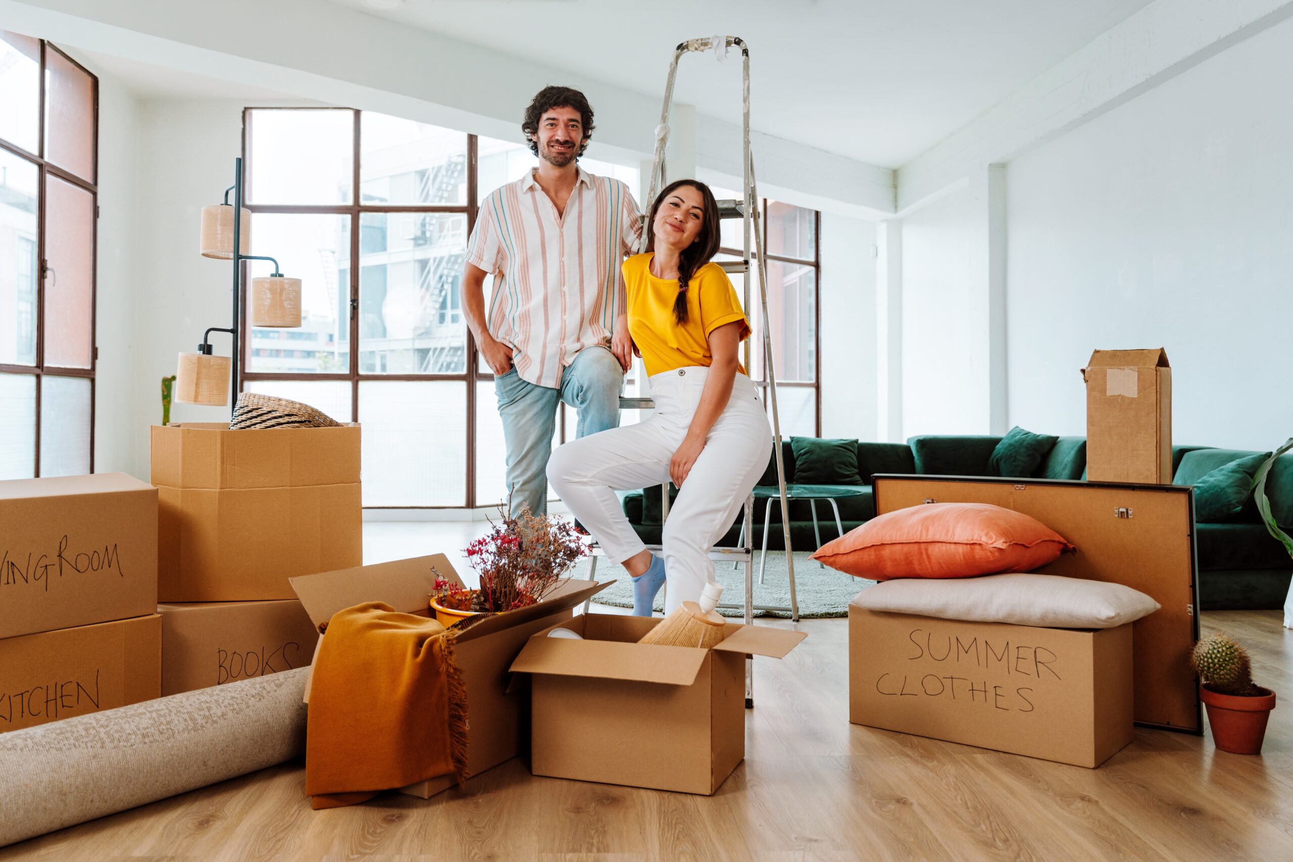 Happy,Young,Couple,Relocating,In,A,New,Apartment.,Young,Woman