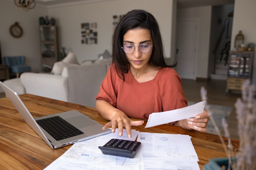 Renter calculating apartment move-in costs including rent security deposit application fees utilities and moving expenses.