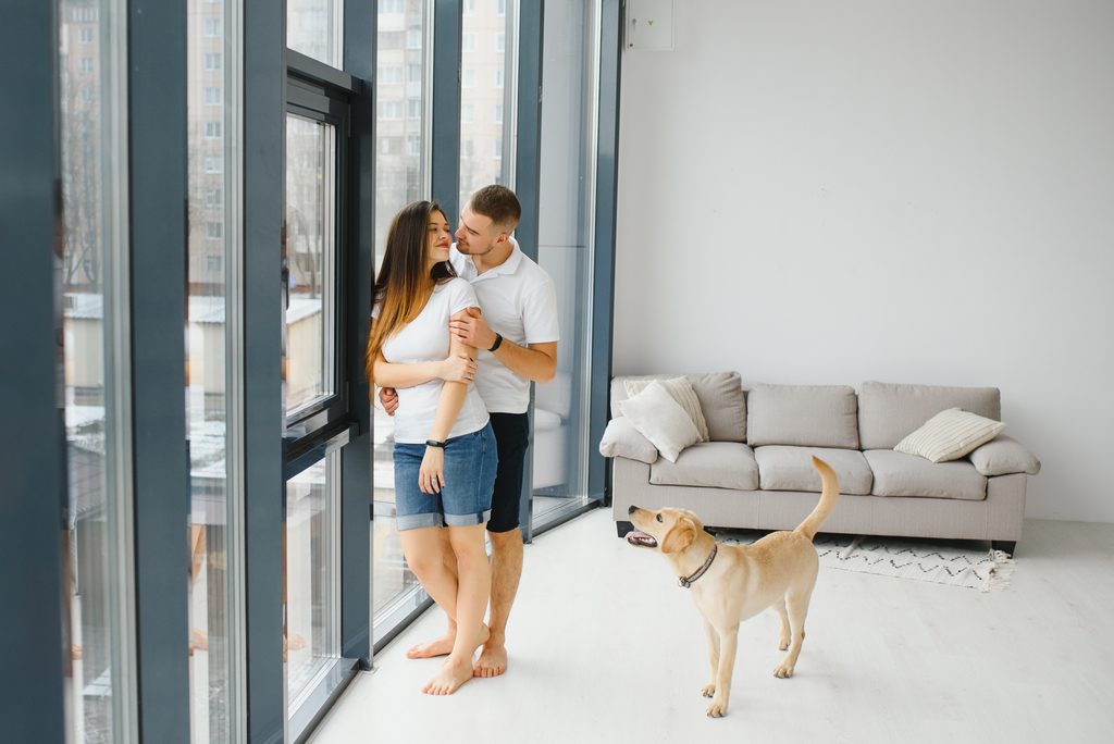 Renter with dog touring a pet-friendly apartment and reviewing pet fees breed restrictions and lease rules
