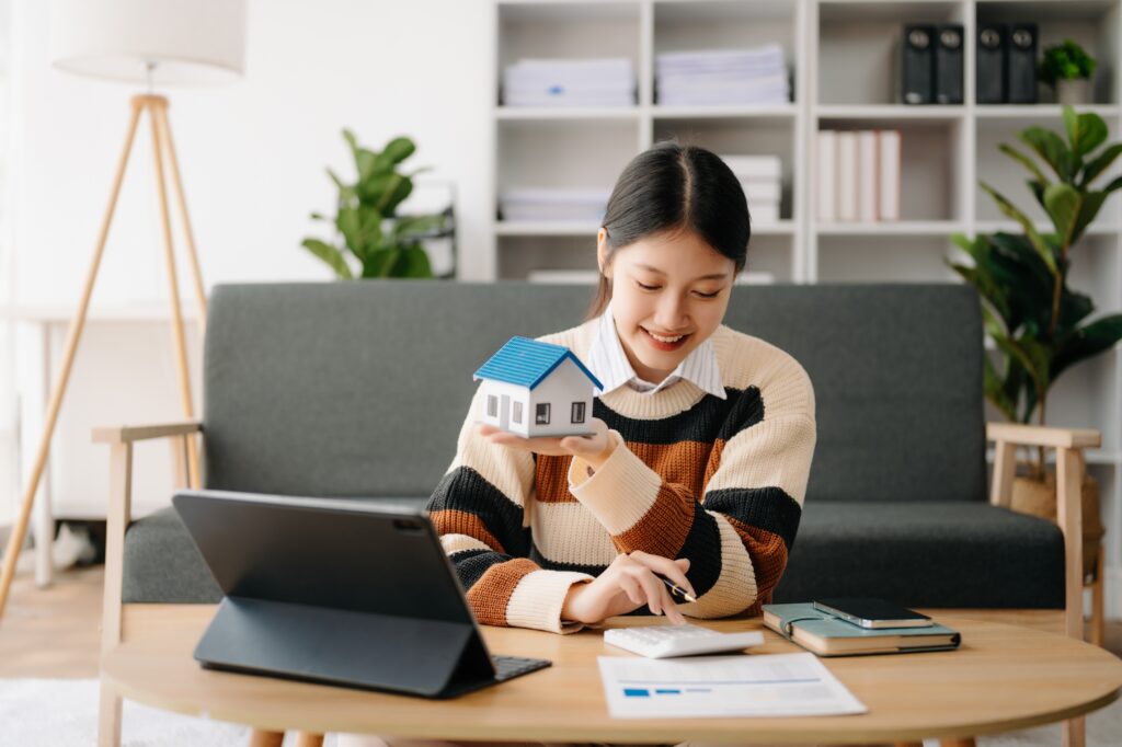 First-time home buyer calculating down payment closing costs moving expenses and emergency savings before buying a house.